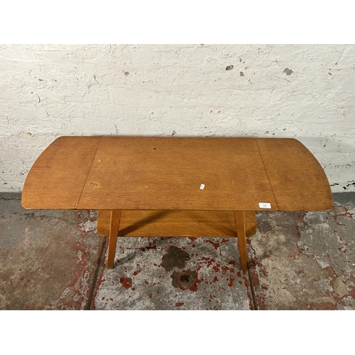 216 - A mid 20th century oak and beech drop leaf coffee table