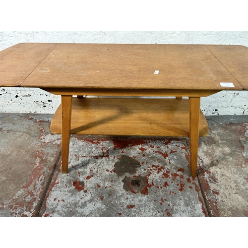 216 - A mid 20th century oak and beech drop leaf coffee table