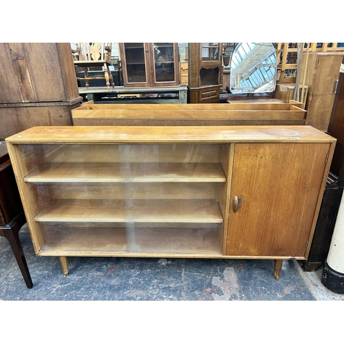 225 - A mid 20th century Herbert E. Gibbs teak bookcase with two glass sliding doors