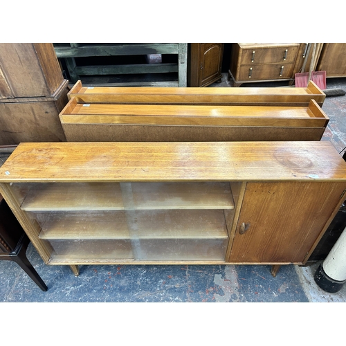 225 - A mid 20th century Herbert E. Gibbs teak bookcase with two glass sliding doors