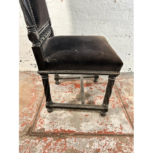 234 - A 19th century heavily carved and ebonised oak hall chair with black fabric upholstery