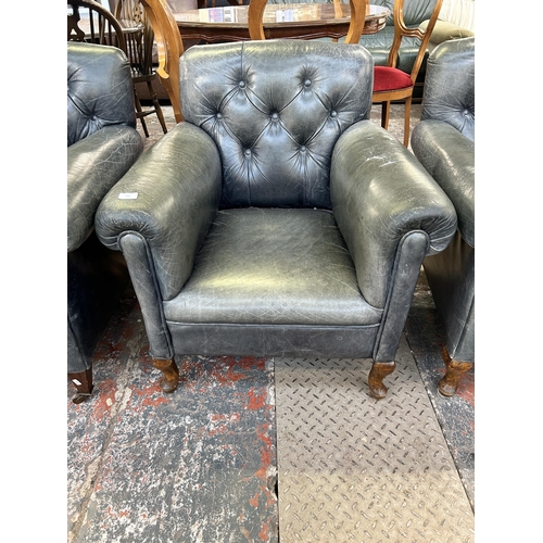 244 - A pair of early 20th century blue leather button back upholstered armchairs on cabriole supports - a... 