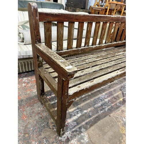 245 - A teak garden bench - approx. 90cm high x 151cm wide x 56cm deep