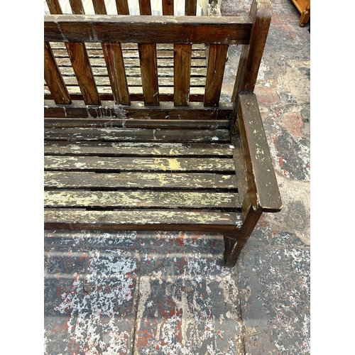 246 - A teak garden bench - approx. 90cm high x 151cm wide x 56cm deep