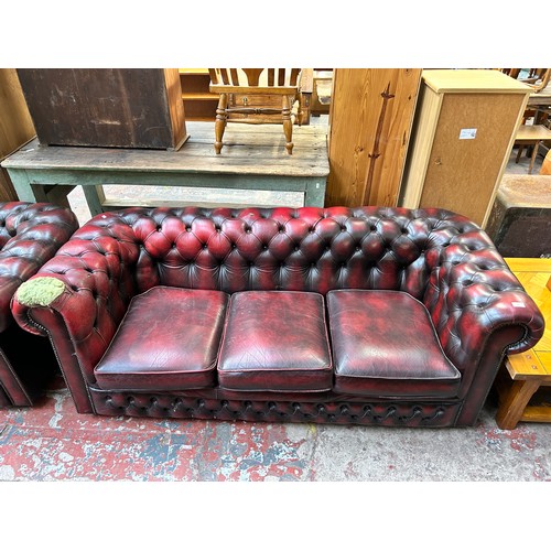 183 - An oxblood leather three seater Chesterfield sofa