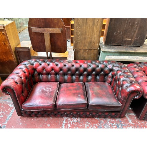 184 - An oxblood leather three seater Chesterfield sofa