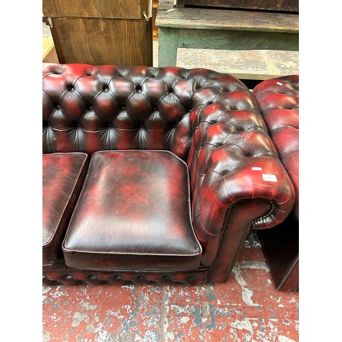 184 - An oxblood leather three seater Chesterfield sofa