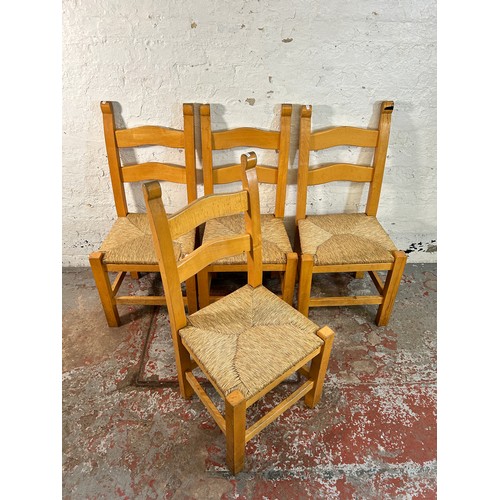 185 - Four beech and rush seated ladder back dining chairs