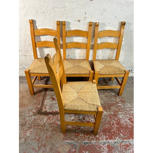 185 - Four beech and rush seated ladder back dining chairs