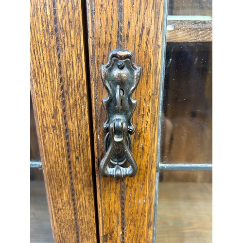 217 - An Arts and Crafts inlaid oak bureau bookcase with two stained and leaded glass doors - approx. 200c... 