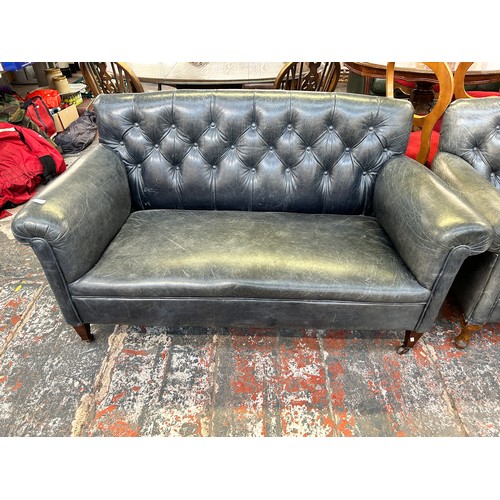 243 - A turn of the century blue leather button back upholstered two seater sofa stamped 