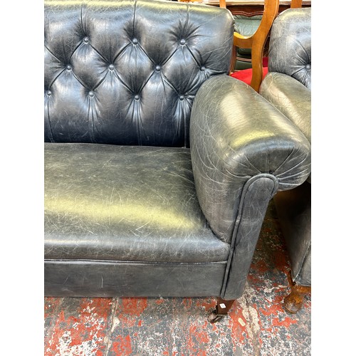 243 - A turn of the century blue leather button back upholstered two seater sofa stamped 