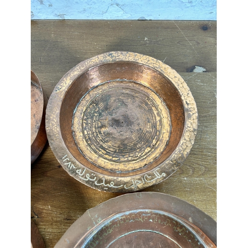 627 - Four antique Middle Eastern copper bowls - largest approx. 23cm in diameter