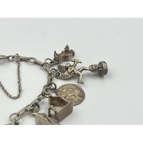 2001 - A silver charm bracelet with assorted charms - approx. gross weight 22.2g