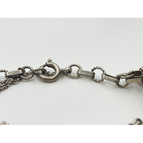 2001 - A silver charm bracelet with assorted charms - approx. gross weight 22.2g