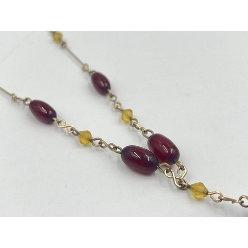 2002 - An Art Deco cherry amber Bakelite beaded and yellow metal necklace - approx. gross weight 7.8g