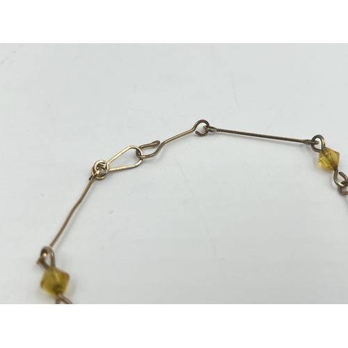 2002 - An Art Deco cherry amber Bakelite beaded and yellow metal necklace - approx. gross weight 7.8g