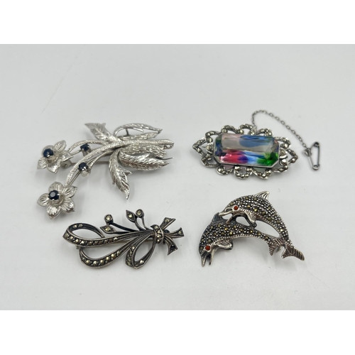 2019 - Four silver brooches to include marcasite set dolphin, sapphire set floral etc. - approx. gross weig... 