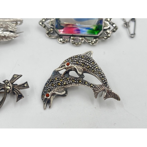 2019 - Four silver brooches to include marcasite set dolphin, sapphire set floral etc. - approx. gross weig... 