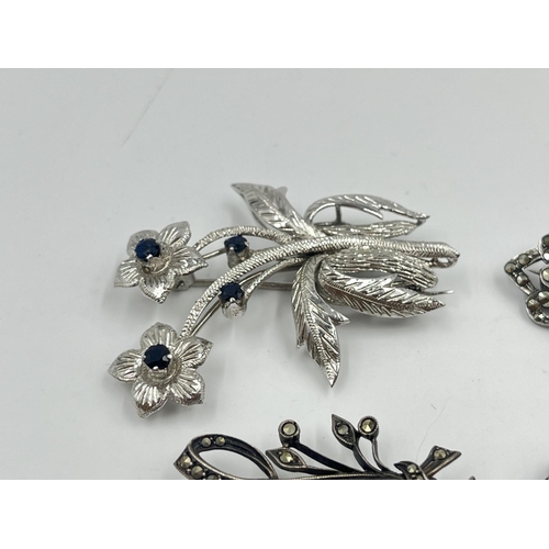 2019 - Four silver brooches to include marcasite set dolphin, sapphire set floral etc. - approx. gross weig... 