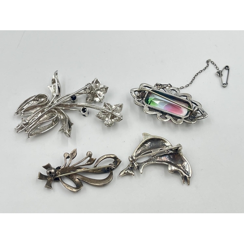 2019 - Four silver brooches to include marcasite set dolphin, sapphire set floral etc. - approx. gross weig... 