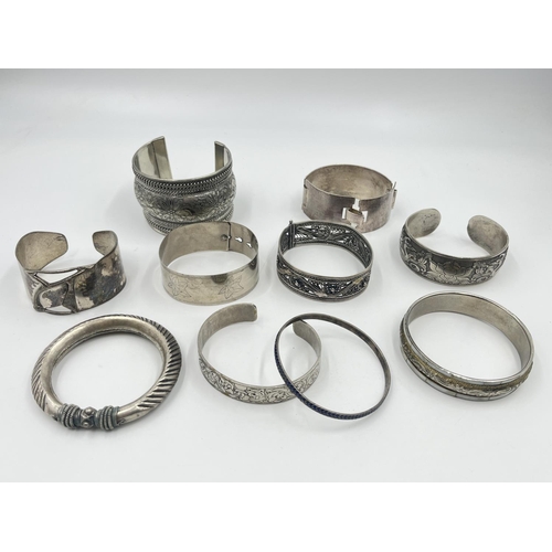 2032 - A collection of white metal cuff bracelets and bangles