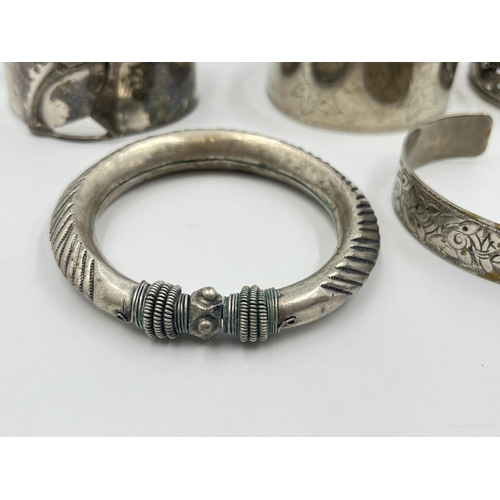 2032 - A collection of white metal cuff bracelets and bangles