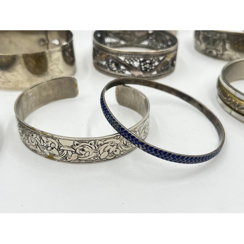 2032 - A collection of white metal cuff bracelets and bangles