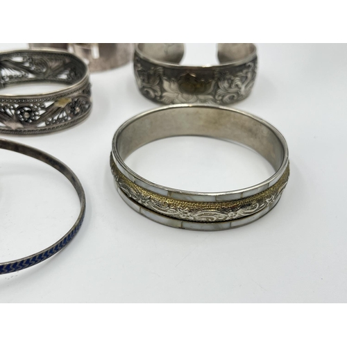 2032 - A collection of white metal cuff bracelets and bangles