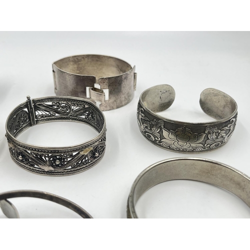 2032 - A collection of white metal cuff bracelets and bangles