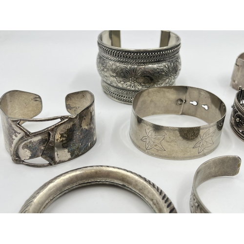 2032 - A collection of white metal cuff bracelets and bangles