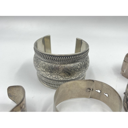 2032 - A collection of white metal cuff bracelets and bangles