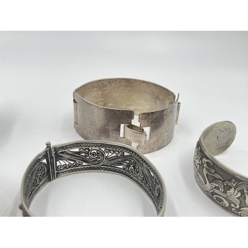 2032 - A collection of white metal cuff bracelets and bangles