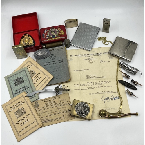 2205 - A collection of items to include cigarette cases, R.A.F. Service and Release book, Zippo tribal cros... 