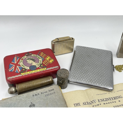 2205 - A collection of items to include cigarette cases, R.A.F. Service and Release book, Zippo tribal cros... 