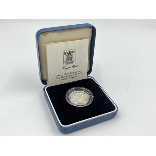 2208 - Two items, one boxed 1989 United Kingdom silver proof £1 coin with certificate and one The Westminst... 