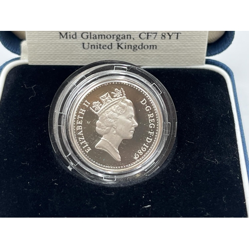 2208 - Two items, one boxed 1989 United Kingdom silver proof £1 coin with certificate and one The Westminst... 