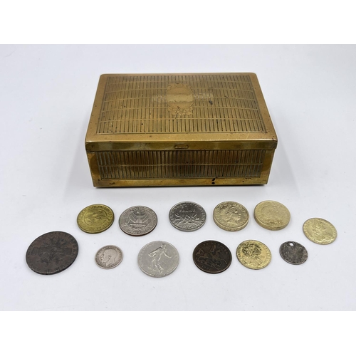 2213 - A mid 20th century brass cigarette box containing 1793 Leek Commercial conder token, 1849 'Cumberlan... 