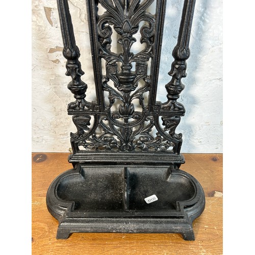 632 - A Coalbrookdale style black cast metal stick stand - approx. 50cm high