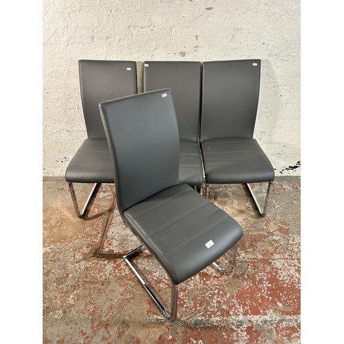 112 - Four modern grey faux leather and chrome plated cantilever dining chairs