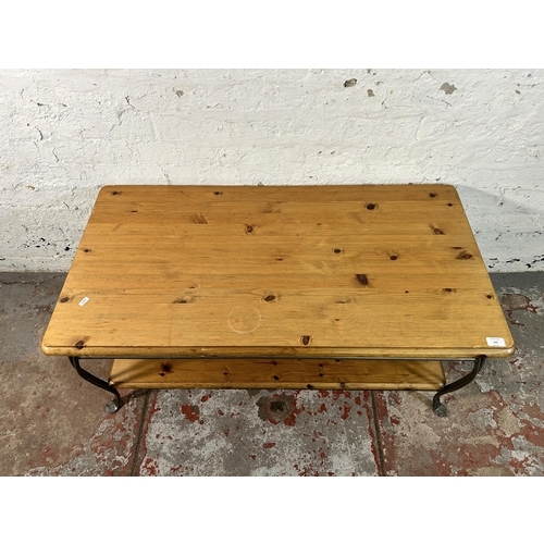 142 - A Ducal pine and wrought iron two tier coffee table