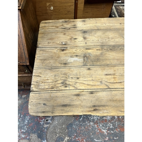 214 - An early 20th century pine trestle table - approx. 75cm high x 61cm wide x 243cm long