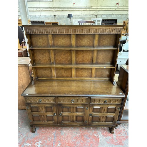 169 - A carved oak dresser - approx. 163cm high x 155cm wide x 50cm deep