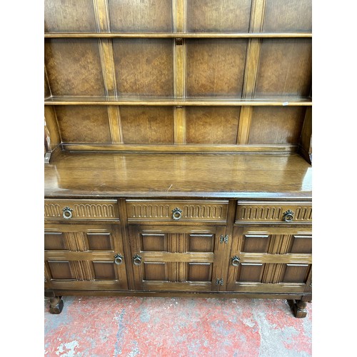 169 - A carved oak dresser - approx. 163cm high x 155cm wide x 50cm deep