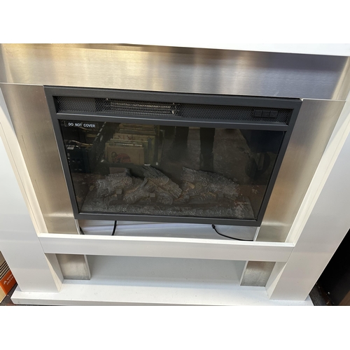 1055 - A Warmlite log burning fire effect electric heater fitted to white laminate surround - approx. 112cm... 