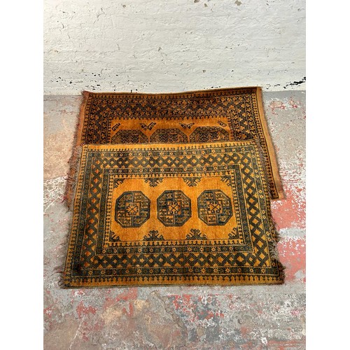 199 - Two mid 20th century burnt orange and black machine woven rugs, one approx. 150cm x 100cm and one ap... 