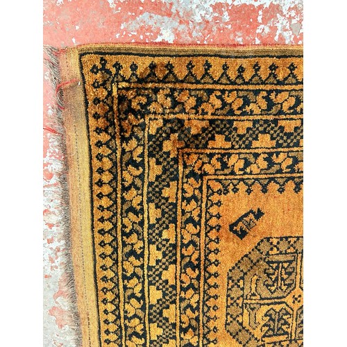 199 - Two mid 20th century burnt orange and black machine woven rugs, one approx. 150cm x 100cm and one ap... 