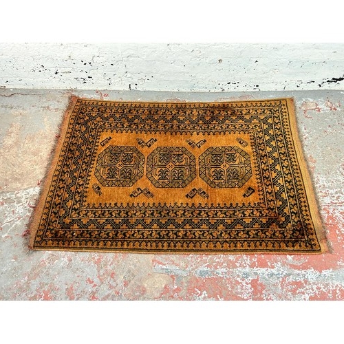 199 - Two mid 20th century burnt orange and black machine woven rugs, one approx. 150cm x 100cm and one ap... 