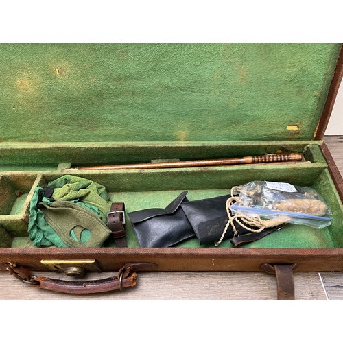 767 - A vintage canvas and leather shotgun case with baize lined interior compartments and oak and brass b... 