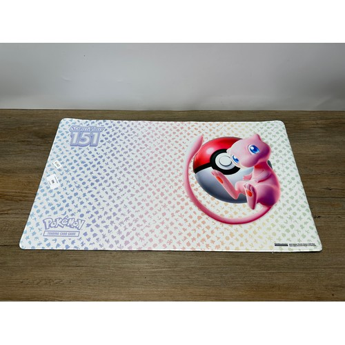 598 - A collection of Pokémon trading cards together with a Game Freak Pokémon themed gaming mat